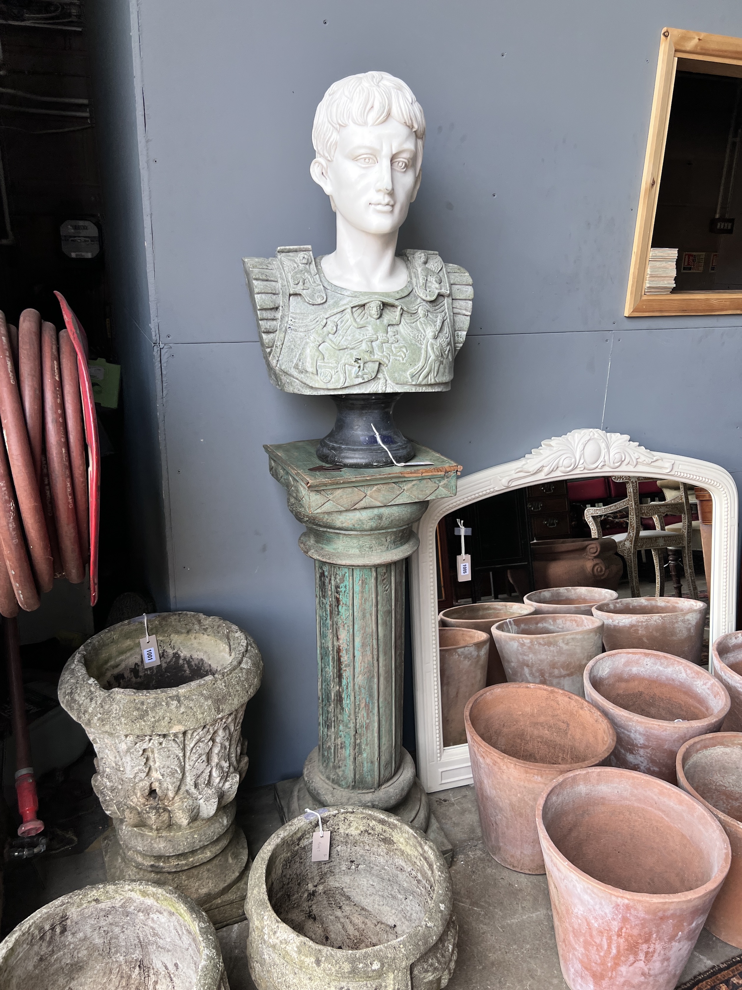 A reconstituted marble bust of a Roman emperor on painted wood plinth, total height 170cm